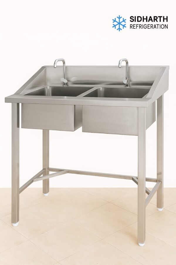 Double stainless steel sink with 2 taps, side splash-proof panel, and drain pipe + coupling included. Perfect for commercial kitchens, hotels, and caterers. Free delivery & setup support.